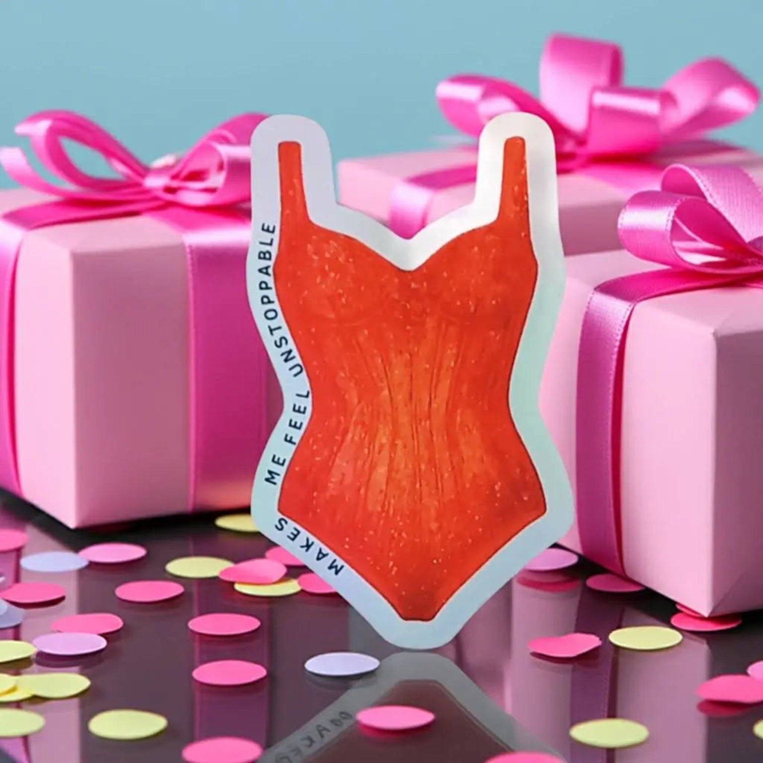 Holographic Taylor Swift sticker of the pink and blue sparkling Lover era bodysuit from the Eras Tour swimsuit design with text on a black background