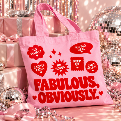 Pink organic cotton tote bag featuring bold red “Fabulous, Obviously.” retro lettering, playful slogan badges and decorative sparkles.