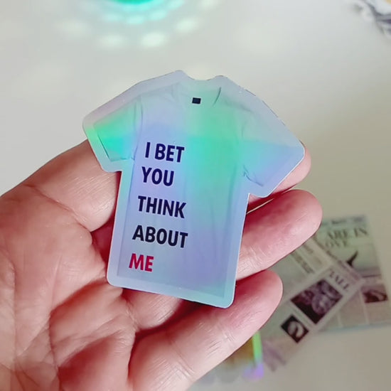 Holographic Taylor Swift sticker of the 22 shirt saying I Bet You Think About Me from the Red Era